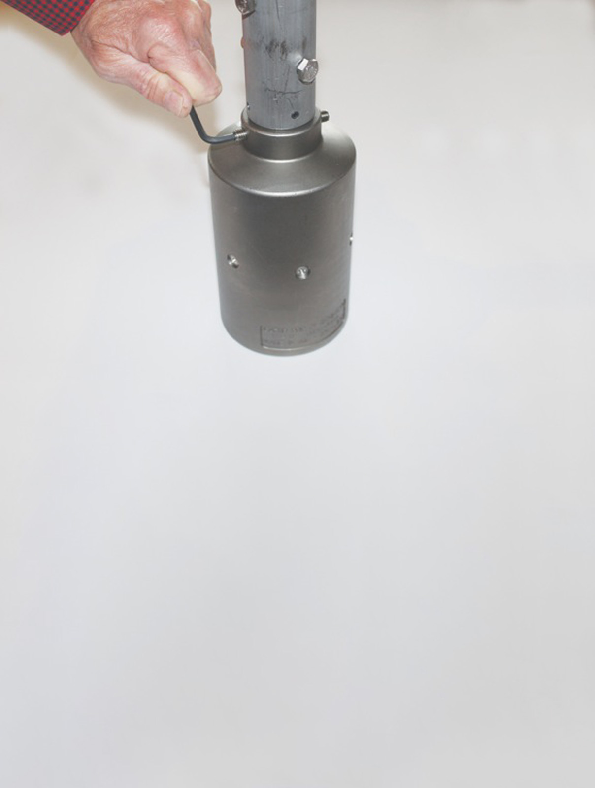 Man adjusting Gator Grip Gate Key with Allen wrench